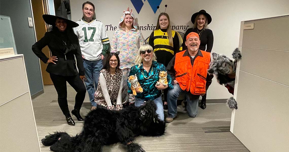 A group of Western National emplpyees posing together in Halloween costumes.